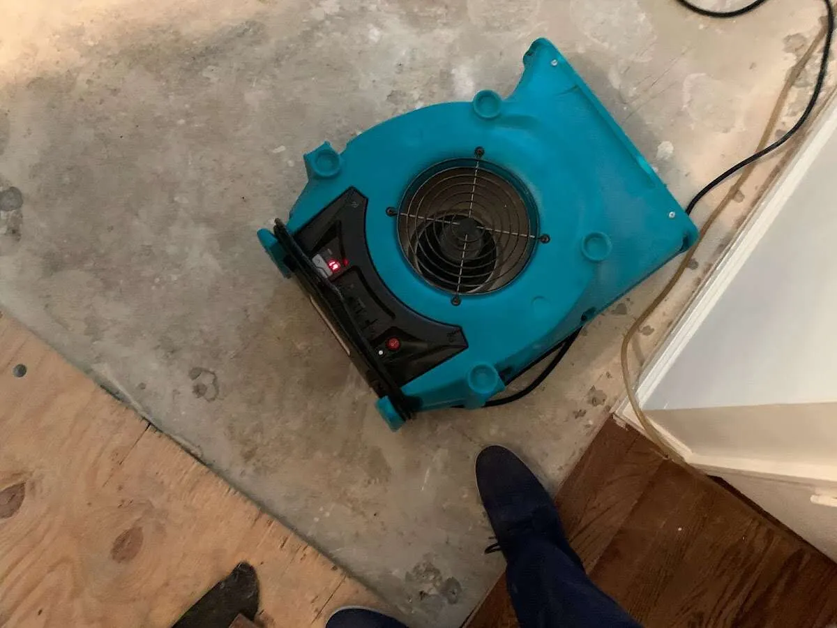 Air mover drying subfloor during Leak Detection & Repair in Wharton